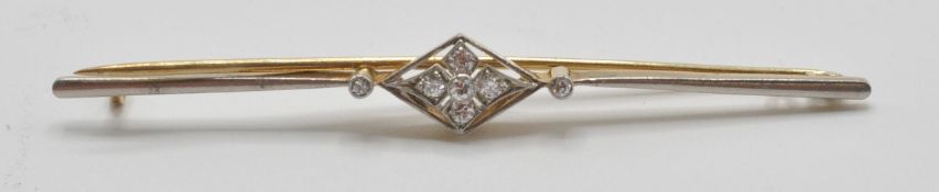 An 18ct gold bar brooch having a central diamond shaped panel set with four round cut diamonds in