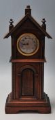 A 20th Century German wooden cased miniature longcase / grandfather clock having a pediment top with