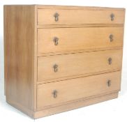 A 1930's Art Deco oak chest of drawers. Raised on an inset plinth base with an upright back of 4
