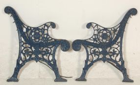 A pair of 20th Century antique cast iron scroll work garden bench ends painted in blue.