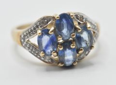 A hallmarked 9ct gold ladies dress ring being set with four oval cut sapphires illusion set with