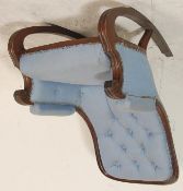A 20th century Victorian style mahogany rocking chair having button back with scroll arm rest and