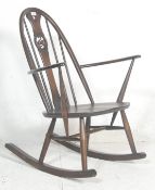 A contemporary 20th century Ercol Furniture beech and elm wood Windsor pattern rocking chair -