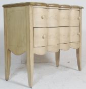 A 20th century Serpentine fronted French painted shabby chic commode chest of drawers. Raised on