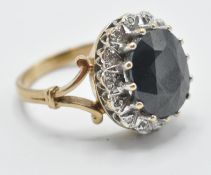 A hallmarked 9ct gold ladies dress ring being set with a large oval cut sapphire with a halo of