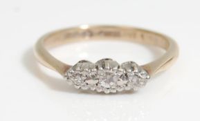 A stamped 9ct gold and platinum ring being set with three round cut white stones in a platinum