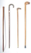 A collection of early 20th Century hardwood walking sticks to include examples with a dog shaped
