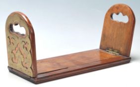 A 19th century Victorian mahogany and brass metamorphic sliding book trough. The trough with brass
