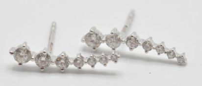 A pair of 18ct white gold seven stone graduated diamond drop earrings with butterfly and heart shape