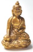 A small gilt cast bronze Chinese Oriental figurine in the form of Buddha seated in the lotus
