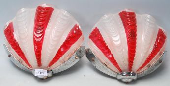 A pair of retro vintage 1960s glass shell wall light shades coloured in cherry and white having a