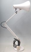 A vintage 20th Century Herbert Terry Industrial anglepoise desk lamp in a white colourway, raised on