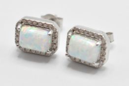 A pair of 925 silver cz and opal earrings having central opal panels with a halo of CZ stones.