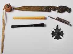 A collection of vintage 20th Century items to include two 1930's cheroot holders, a silver