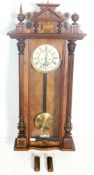 An early 20th century mahogany cased Vienna regulator wall clock having a pediment top flanked by