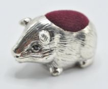 A stamped 925 sterling silver pincushion in the form of a guinea pig with velvet cushion to the