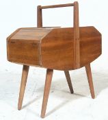 A vintage 20th century circa 1970's stylish teak wood sewing box with hinged lids, handle above