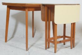 A mid century, circa 1950's blue formica kitchenette dining table being raised on beech wood table