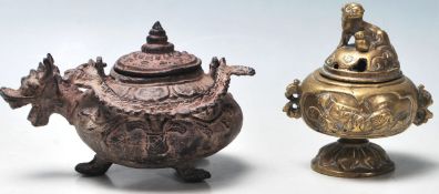 An antique chinese early 20th Century brass censer having a perforated lid with a fu dog on top over