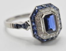 A platinum sapphire and diamond cocktail ring. The ring set with a central octagon cut sapphire with