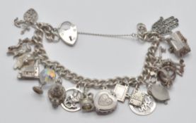 A good silver 925 charm bracelet adorned with multiple charms to include temple, globe, heart