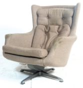 A retro mid century / 1970's period swivel easy chair - armchair. The chair being raised on a four