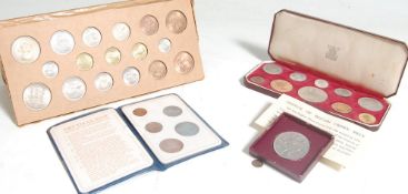 A collection of coin sets to include ER Coronation set in burgundy leather presentation case, Silver