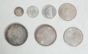 A collection of 7 antique British coins all dating from 1887 to include a Crown, Double Florin, Half