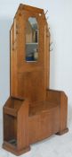 A 1930's Art Deco oak hall stand - settle bench. The hallstand with centre seat having hinged top