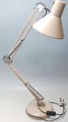A vintage 20th Century Herbert Terry style Industrial anglepoise desk lamp in a beige colourway,