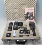 A vintage 20th century OLYMPUS OM- 1 N 35mm camera in a aluminium carry case along with flash,