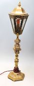 An early 20th Century brass desk lamp in the style of a Victorian street lamp having a fire shaped