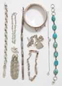 A group of silver bracelets to include a turquoise cabochon bracelet, a hanged bangle with