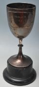 A silver hallmarked trophy of typical form raised on an ebonised socle plinth. The trophy being