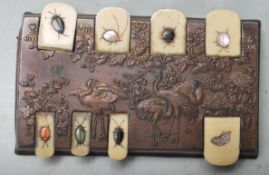 A 19th century Japanese bronze and ivory game / score counter having hinged ivory tokens with mother