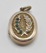 A late 19th / early 20th Century Victorian / Edwardian gilt locket having a crossed wheat sheath