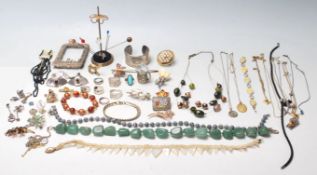 A collection of vintage 20th Century jewellery to include a Tiffany style bangle, a green stone