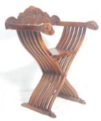 An antique style 20th Italian walnut Tuscan carved Savonarola throne chair having shaped base with