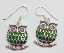 A pair of silver 925 plique a jour earrings in a form of a owl sitting on a branch with red stone