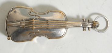 A vintage 20th Century silver plated vesta in the form of a violin having a match strike to the