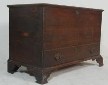 An 18th century country oak coffer chest trunk. Raised on bracket feet with short drawers under