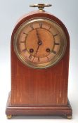 An early 20th Century Edwardian dome top mantel clock having an inlaid oak body with a brass and