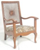 A 1930's Art Deco walnut bergere cane worked fireside armchair. Raised on cabriole legs with pad