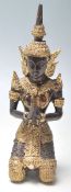 A 20th Century South East Asian Thai figurine in the form of a kneeling Buddha wearing gilt