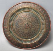 A late 19th century early 20th century Southern Indian bronze charger with central decoration of a