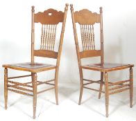A pair of early 20th century American Arts & Crafts oak dining chairs. Each raised on turned legs