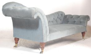A Victorian 19th century double scroll end chesterfield sofa settee / chaise longue. Raised on