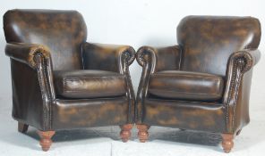 A pair of Antique style leather club - Chesterfield armchairs. Raised on turned legs with leather