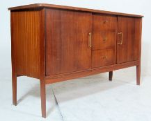 A vintage mid 20th century teakwood sideboard with oversized shaped top, bank of three drawers to