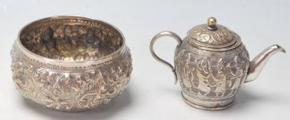 A 20th century antique Burmese repousse white metal bowl with typical oriental decoration to the